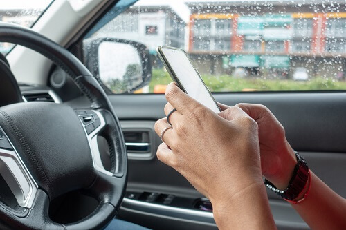 woman texting and distracted driving